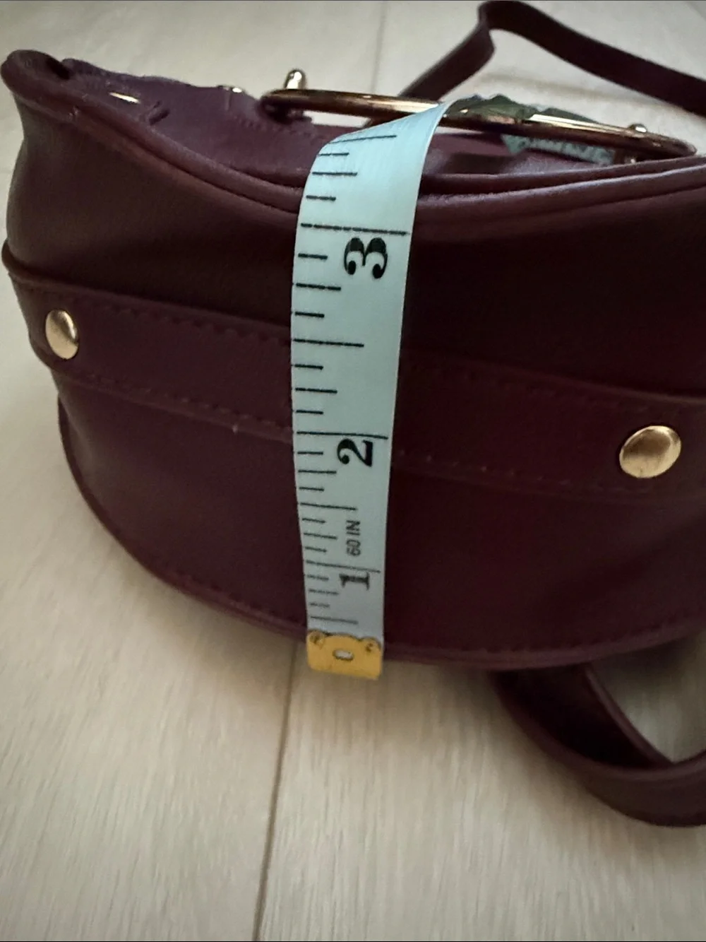 Round Crossbody Bag in Plum with Gold Accents